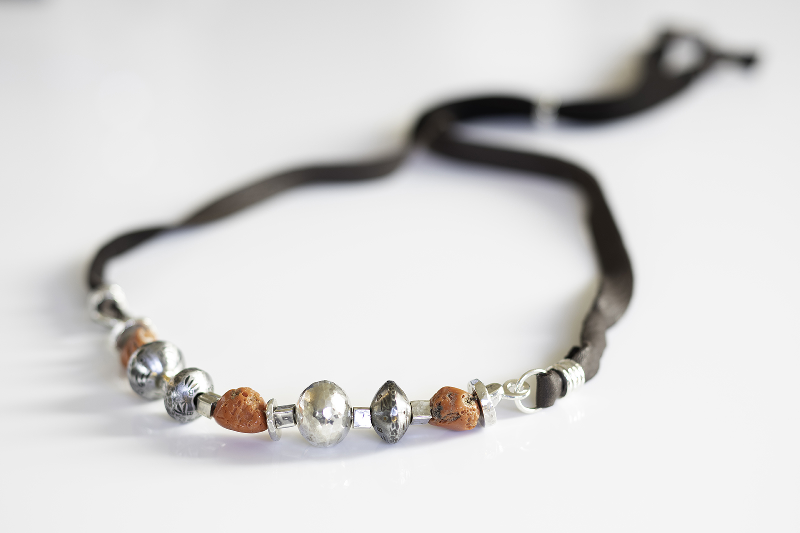 Necklace of silver, steel, coral beads.