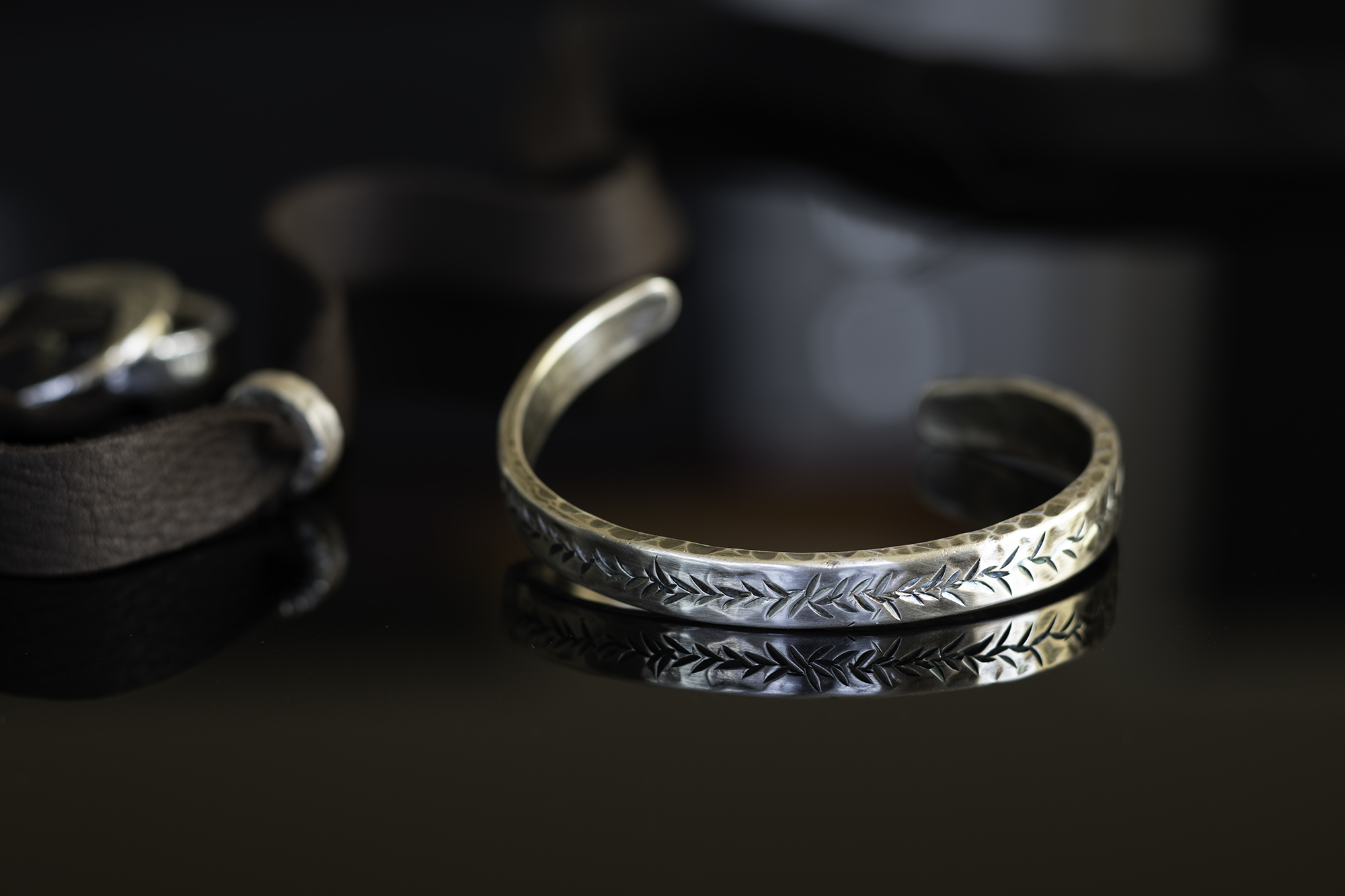 Twisted cuff on dark tabletop.